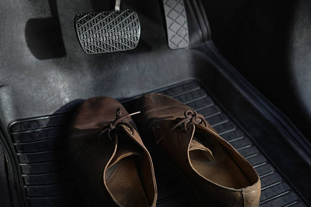 istock Shoes are under the car brakes. 2247539711