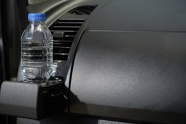 Drinking water in the car prepared for traveling