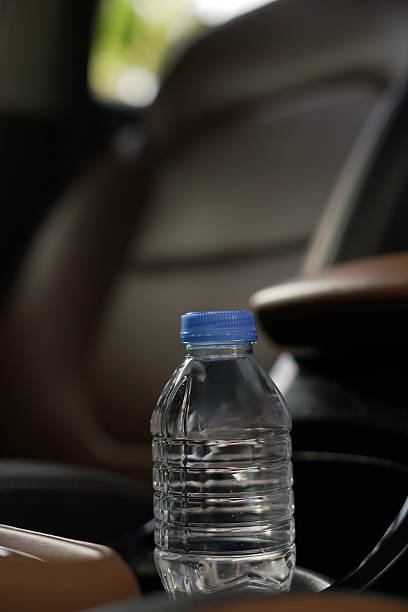 istock Drinking water in the car prepared for traveling 2247542489