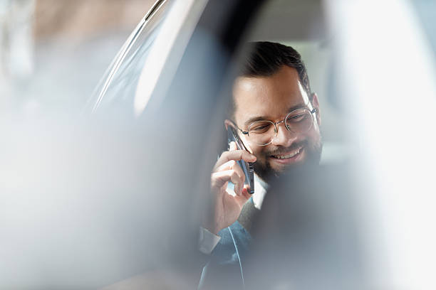 istock Businessman Talking on Phone Inside Car 2247542657