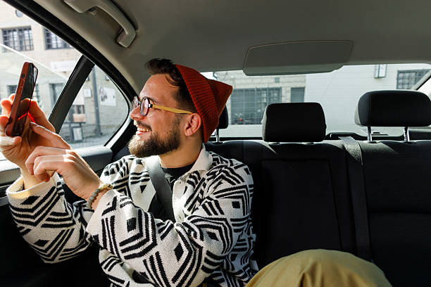 istock Man Having Video Call in Car Backseat 2247542666