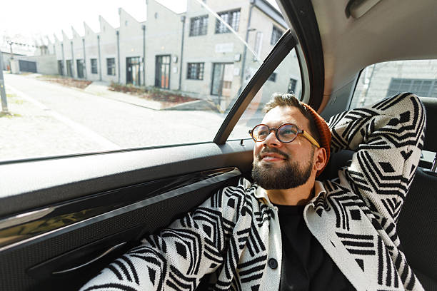 istock Cheerful Man Relaxing in Car Backseat 2247542679