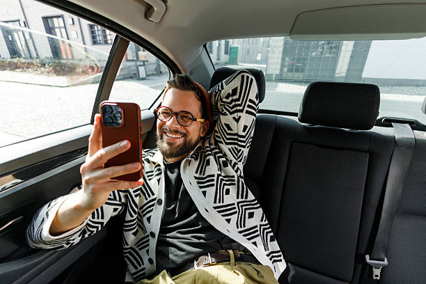 istock Man Having Video Call in Car Backseat 2247542689