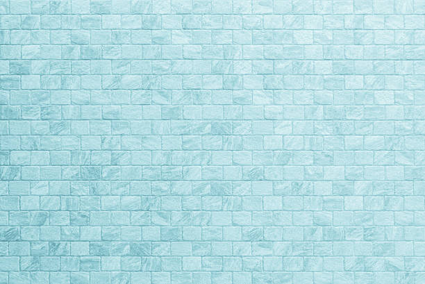 Close up of a a wall, tiled with square ceramic tiles