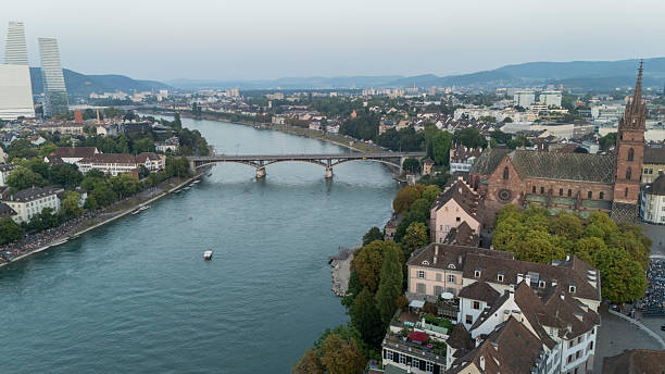 A river with a bridge in the background. The water is calm and the sky is dark. The scene is peaceful and serene