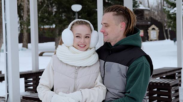 istock Winter landscape revealing affectionate young couple cuddling, wearing cozy outerwear, sharing intimate embrace amid snow covered park scene 2247545376