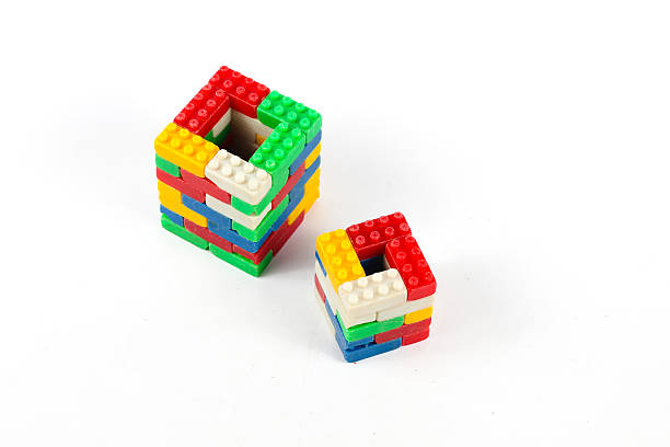 Colorful used plastic blocks forming a chimney isolated on a white background