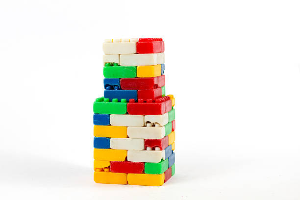 istock Colorful used plastic blocks forming a chimney isolated on a white background 2247545989