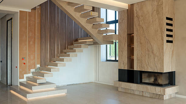 istock Modern floating staircase with integrated lighting and a stone fireplace 2247549333