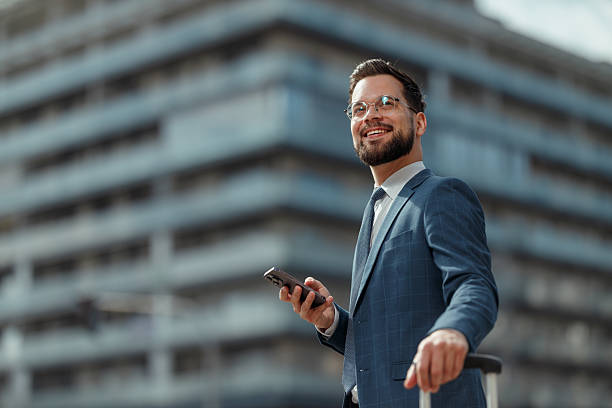 istock Smiling Businessman Using Smartphone Outdoors 2247550035