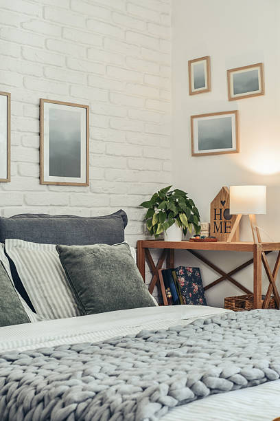 istock Stylish interior of bedroom with big comfortable grey bed 2247550755
