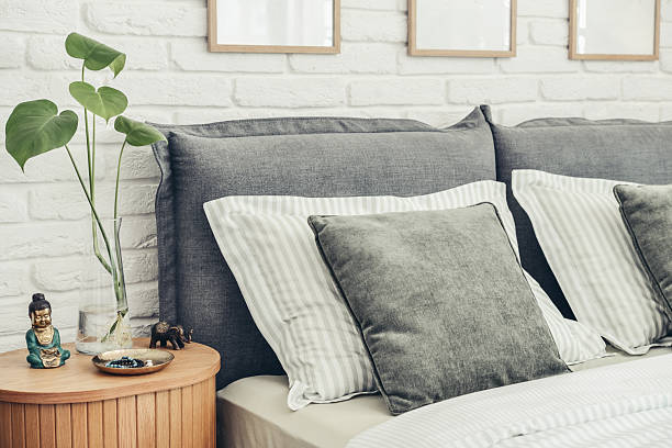 istock Stylish  big comfortable grey bed with striped bed linen 2247550815