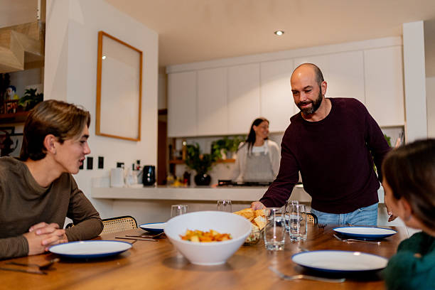 istock Family setting the table to dinner at home 2247552937