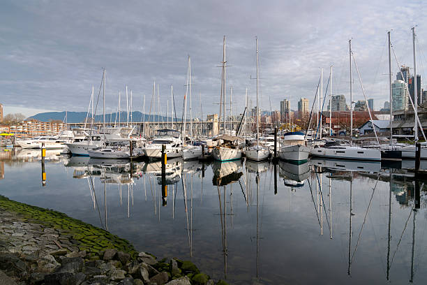Yachts in Granville Island Marina on a sunny afternoon. Vancouver, British Columbia, Canada. March 17, 2021.