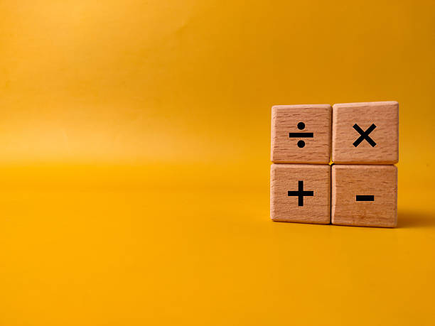istock The image displays four wooden blocks with basic mathematical operation symbols on a yellow background 2247555594