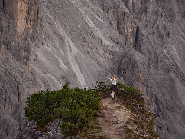 Young woman feeling freedom and adventure while hiking in the mountains.