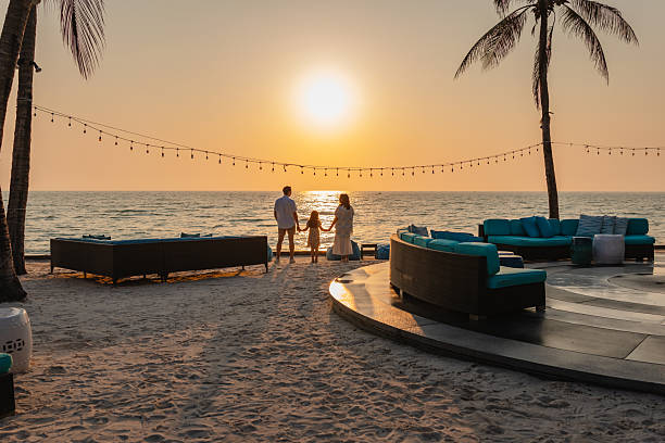 istock Family holding hands enjoying sunset on the beach 2247560791