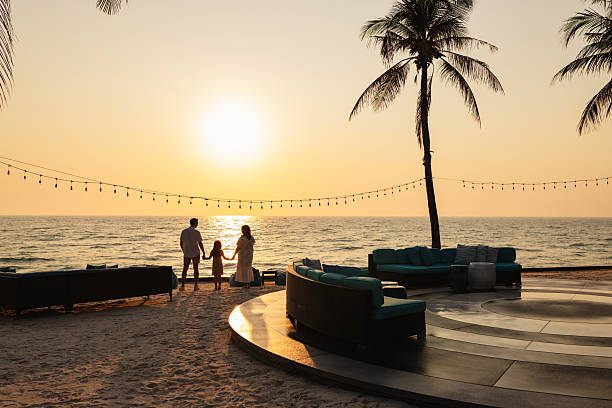 istock Family holding hands enjoying sunset on the beach 2247560833