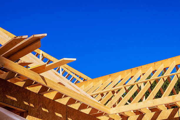 istock Construction of wooden roof frame under trusses studs at building site 2247560891