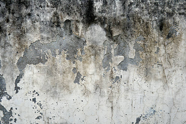 istock Aged Concrete Wall with Heavy Peeling Paint and Weathered Texture 2247561177
