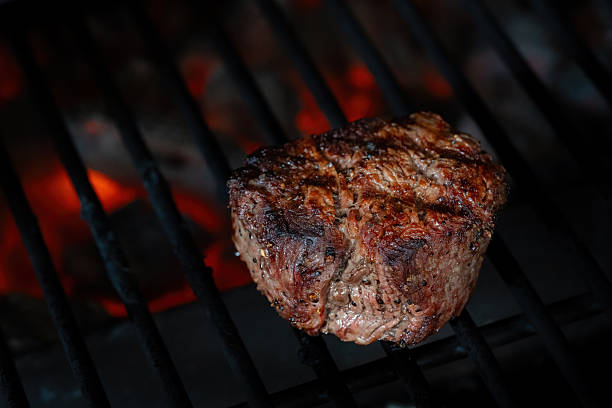 istock a beef steak being grilled over hot coals 2247562581