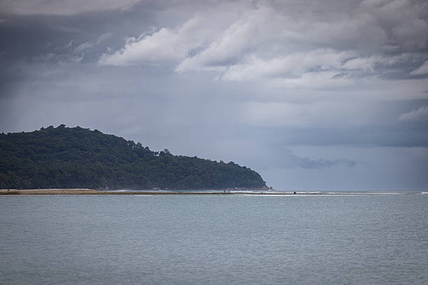 Tropic beach view with storm clouds and rain.Phuket - Thailand.