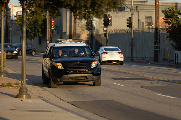 istock Two On Duty Police Officers Driving Towards Setting Sun 2247565652
