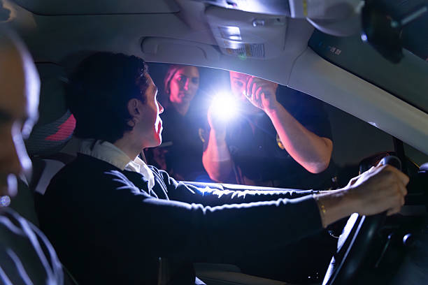istock Police Officer Uses Flashlight for Field Sobriety Test of Driver 2247565760