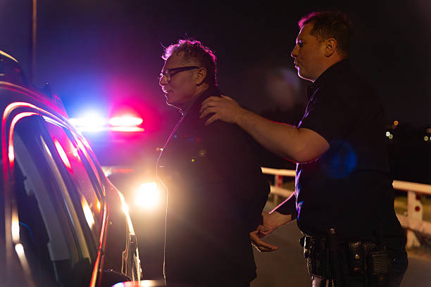 istock Police Officer Handcuffs Driver During Traffic Stop 2247565779