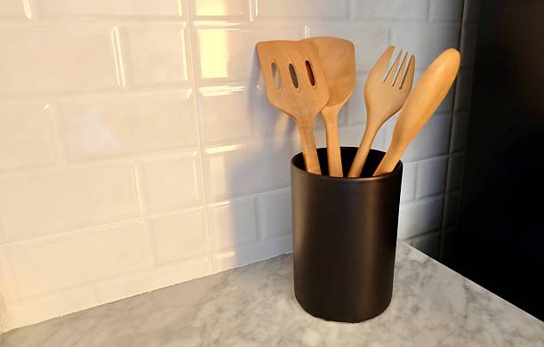 istock Wooden Kitchen Utensils in Black Canister on Marble Countertop 2247569145