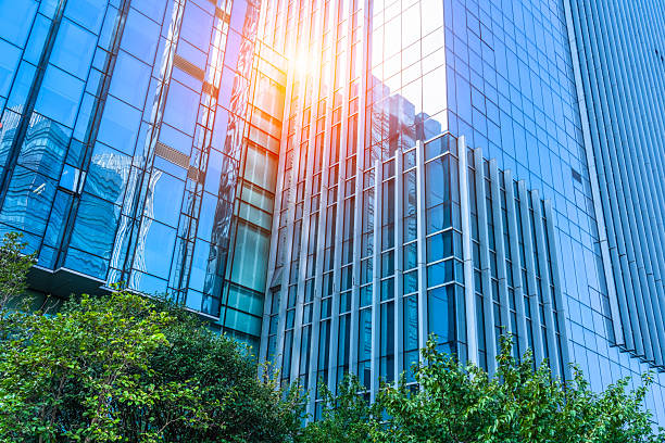 istock Modern glass buildings and green trees. 2247569166