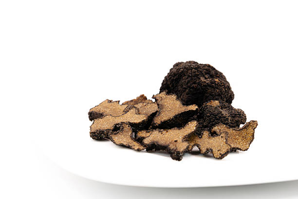 istock Cut and whole black truffles isolated on white 2247569397