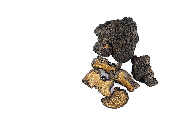 istock Cut and whole black truffles isolated on white 2247569400