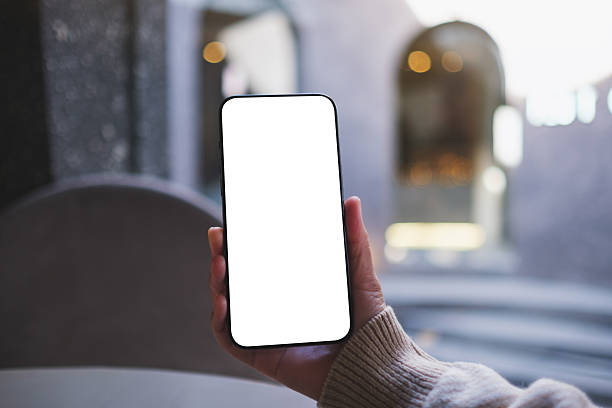 istock Mockup image of a woman holding and using mobile phone with blank desktop screen in cafe 2247569939