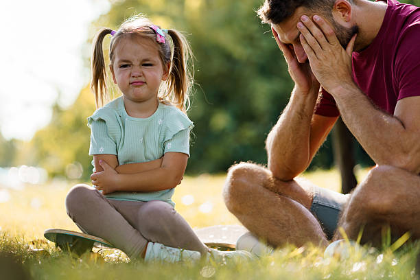 istock Stubborn little girl causing father stress in park 2247570911