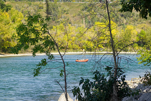istock Turquoise river with kayaks and forested banks 2247578845