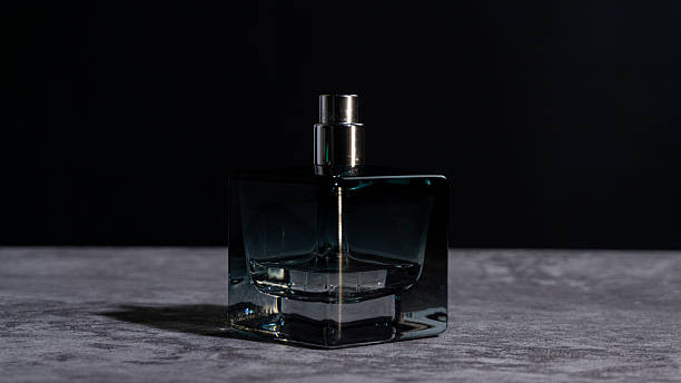 istock Perfume bottle standing upright on a stone surface with dramatic shadows and clean background, ideal for luxury branding, beauty advertising, and minimalist product concepts. 2247578920
