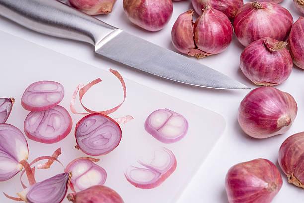 onion or shallot and knife put on the cutting board group small and large on white background.