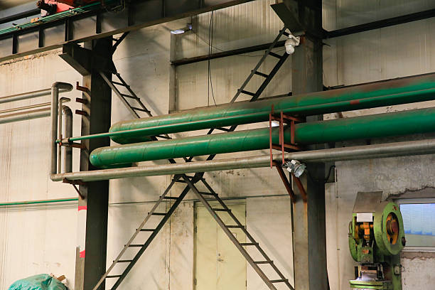 Industrial pipes, control valves and storage tanks in steel mills.