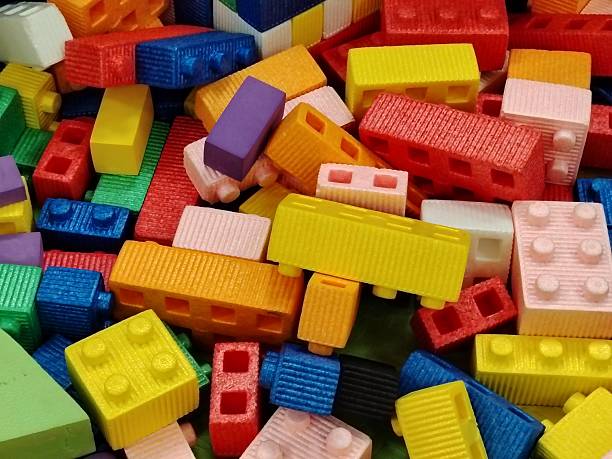 istock Heap of colorful, oversized plastic building blocks and construction bricks. 2247584314