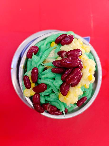 A bowl of cendol, a Malaysian traditional shaved ice dessert served in coconut milk topped with red beans and sweet corns