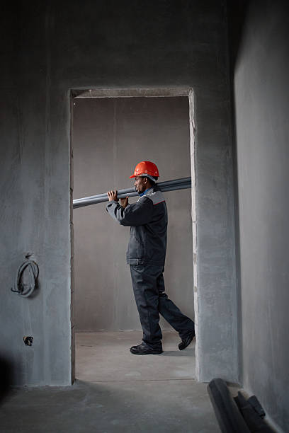 istock Middle Aged Black Man Carrying Construction Materials Inside Unfinished Building 2247586682