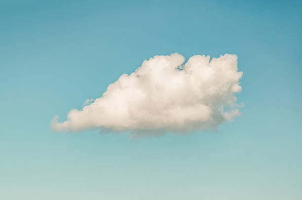 Close-up of a single large white cloud against a blue sky