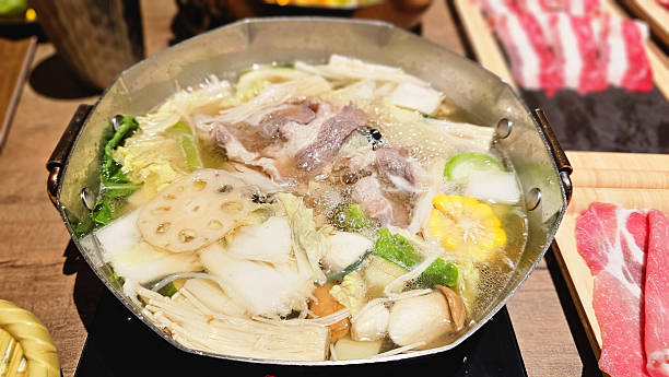 istock A premium Japanese shabu-shabu dining table set with assorted meats, fresh vegetables, hot pot broth,  full-set courses in an Asian restaurant, comforting flavors, warm steam, relaxing gourmet 2247587375