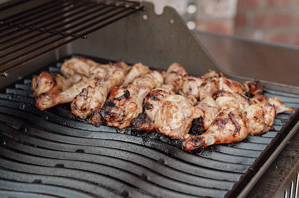 istock Close-up of grilled chicken drumsticks on a grill 2247588030