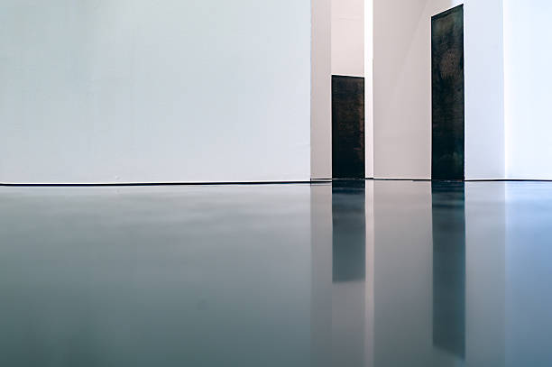 An evocative space where walls seem to hold memory and shadows breathe with life. The interplay of light and architecture transforms human figures into fleeting echoes, capturing a timeless moment of silence and reflection