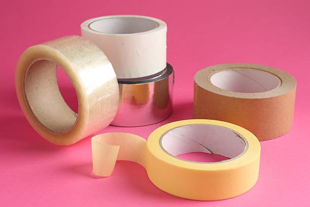 istock Rolls of different adhesive tapes on pink background, closeup 2247588893