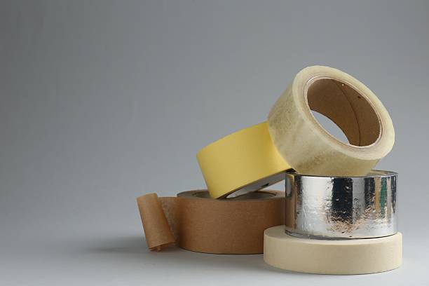 istock Rolls of different adhesive tapes on grey background, space for text 2247588916