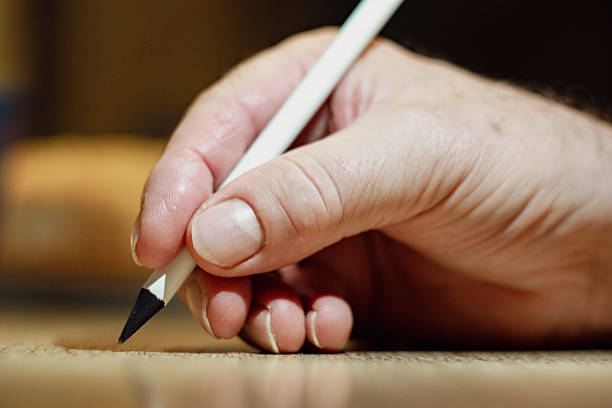 Close-up of a writing hand with a pen