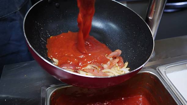 istock Spaghetti with bacon, onions, and tomato sauce in red pan 2247590511